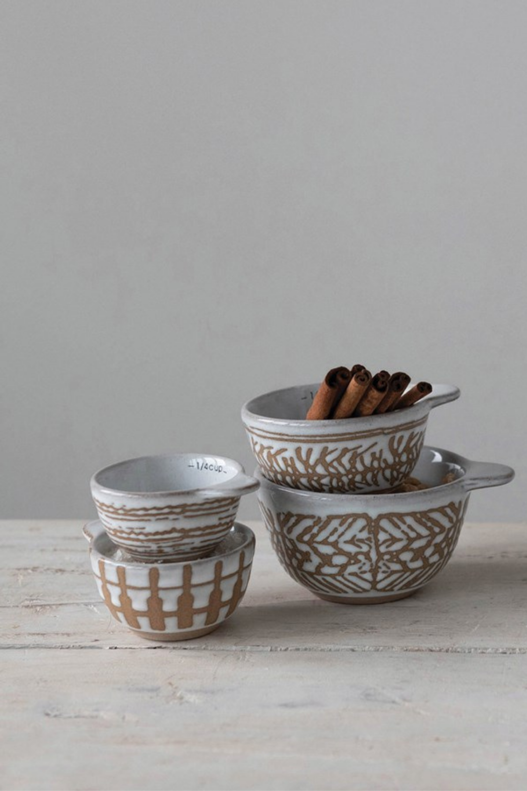 https://ecovibestyle.com/cdn/shop/products/Creative-CoOp-Etched-Ceramic-MeasuringCups-Set-1_2400x.png?v=1678868694